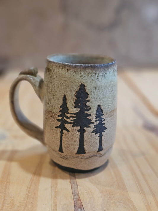 Handcrafted Ceramic mug with tree design handle has thumb rest made in Northern Idaho