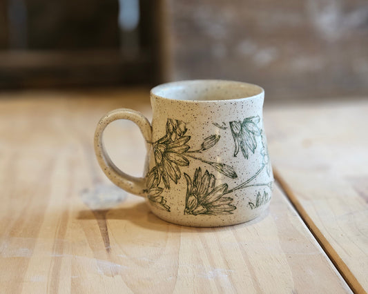 Full bellied wheel thrown pottery mug in a green daisy design - made in Idaho