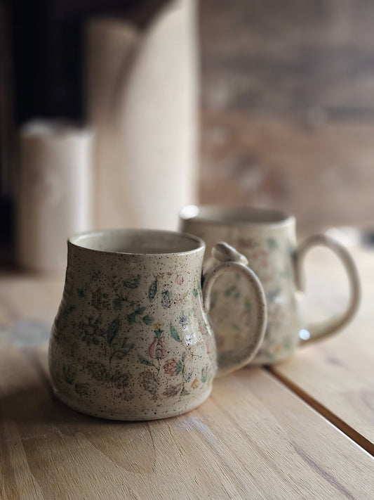 full bellied handmade pottery mug, wildflowers surround all sides, made in Hayden, Idaho