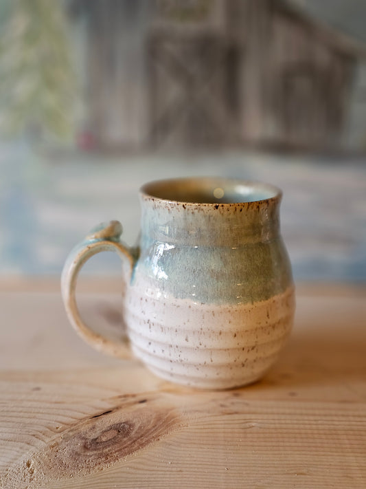 handmade stoneware mug with carved lines and thumb rest - blue rim over white  glaze - handcrafted northern idaho