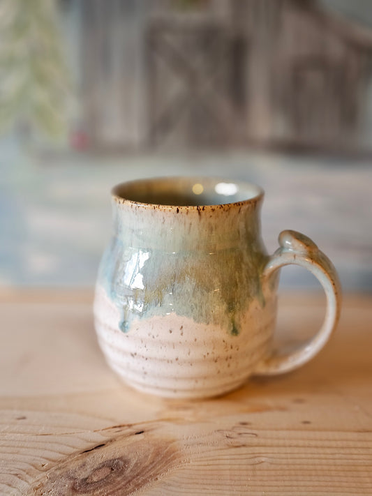 handmade stoneware mug with carved lines and thumb rest - blue rim over white  glaze - handcrafted northern idaho