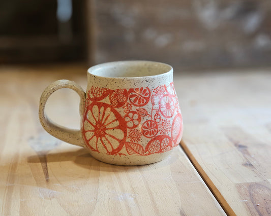 Cheerful citrus design in red on full bellied mug - handmade in northern Idaho