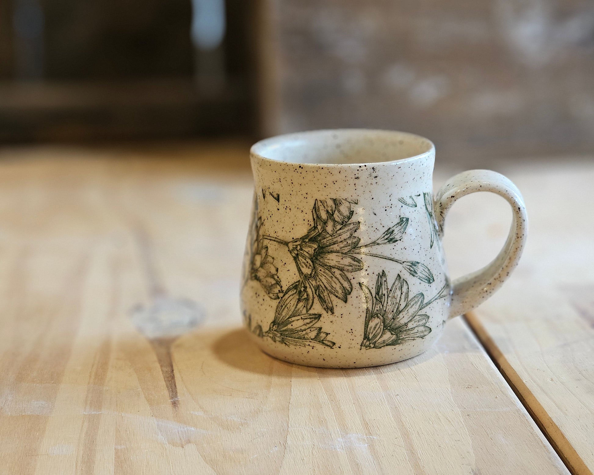 Full bellied ceramic mug in a green daisy design - made in Idaho